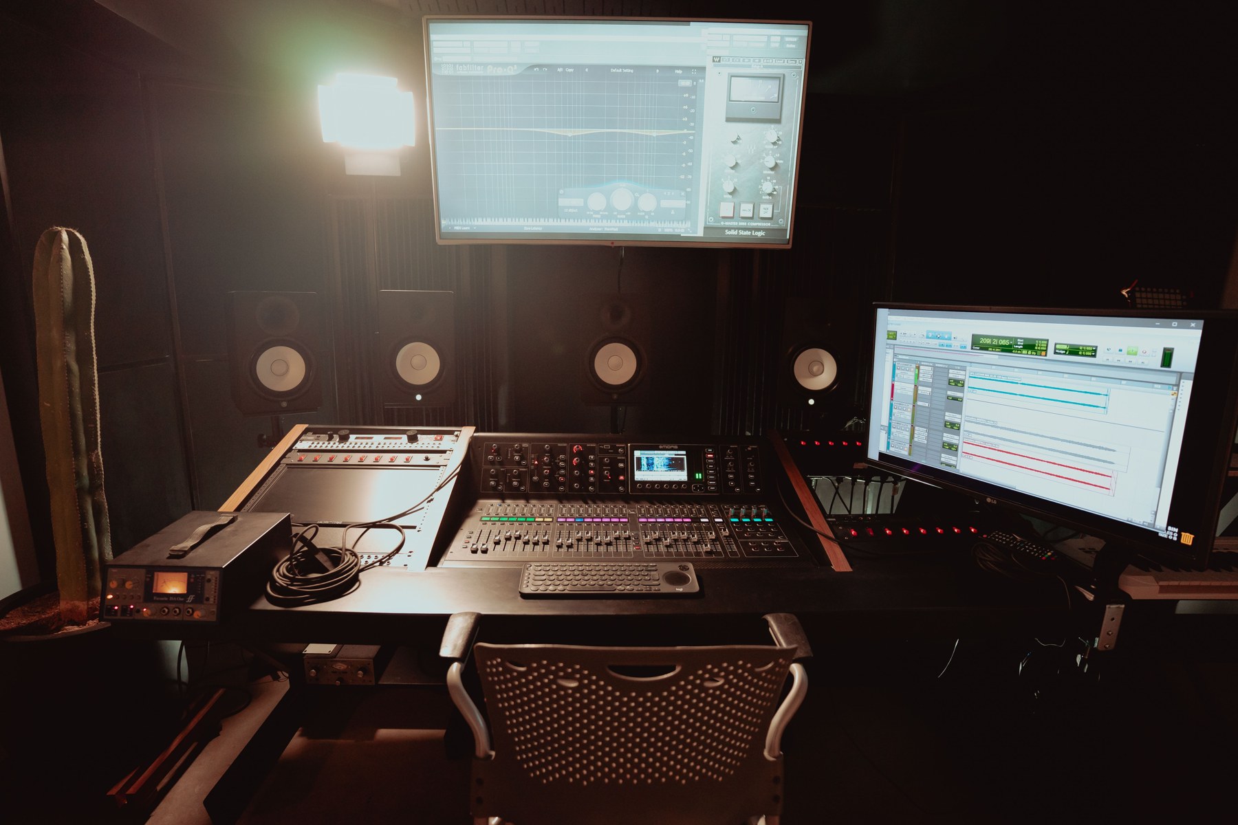 Recording studio control room with mixing console and reference monitors